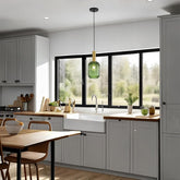 Modern kitchen with gray cabinets, wooden countertops, and a green pendant light.
